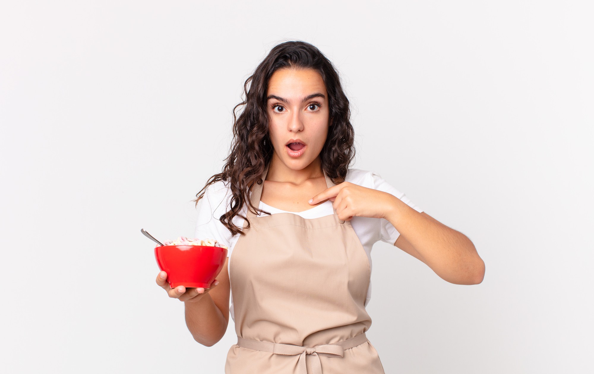 Student tasting a sauce in a small bowl